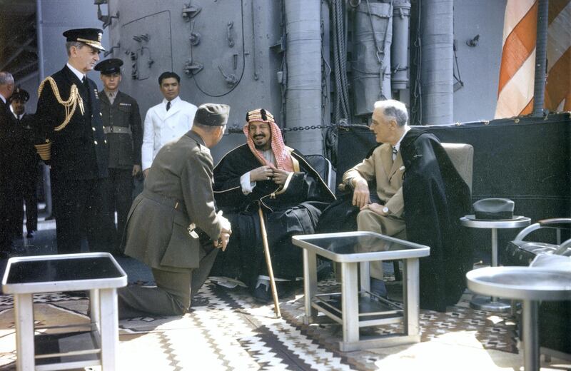 Aboard the USS Quincy in Great Bitter Lake, King Abdul Aziz Ibn Saud of Saudi Arabia (1875 - 1953) (center) speaks to American Marine Corps translator Colonel William A Eddy (1896 - 1962) (kneeling left) as US President Franklin D Roosevelt (1882 - 1945) listens, Egypt, February 14, 1945. (Photo by National Archives/Interim Archives/Getty Images)