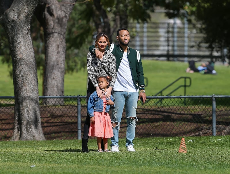 The couple attend their son Miles's baseball game with daughter Luna, on March 5, 2022. Reuters