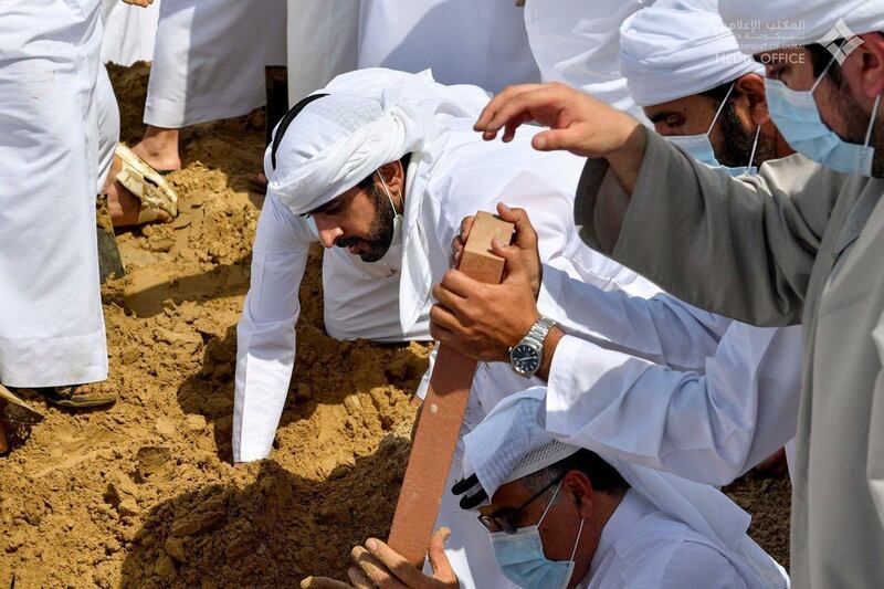 Hamdan bin Mohammed and Maktoum Bin Mohammed carry the body of the late Sheikh Hamdan bin Rashid Al Maktoum to his final resting place in Umm Hurair cemetery in Dubai. Dubai Media Office