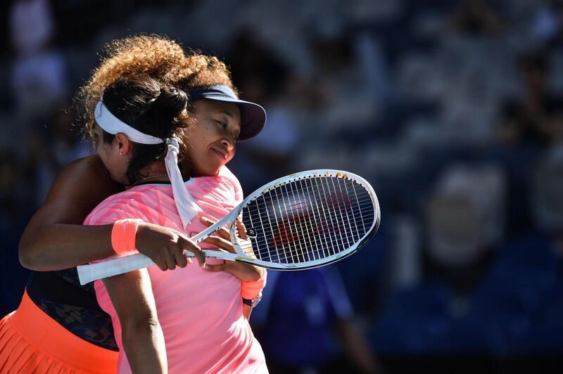 Naomi Osaka hugs Ons Jabeur after their third round match on day five of the Australian Open. AFP