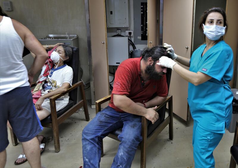 People injured in the Beirut port explosion receive first aid at Najjar Hospital in Al Hamra area in Beirut.  EPA