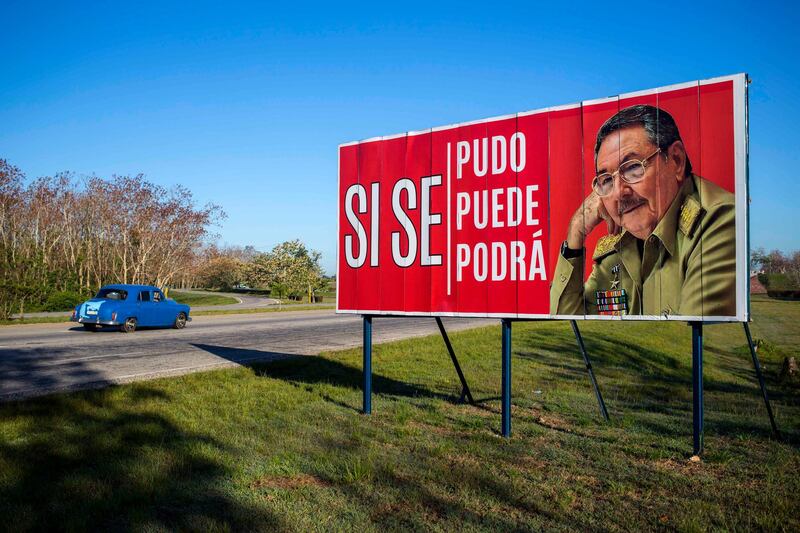 A car drives by a billboard that reads in Spanish 'Â¨Ãt was, is and will be done,Â¨ with a picture of Cuba's President Raul Castro on the outskirts of Havana, Cuba, Wednesday, April 18, 2018. Cuba's legislature opened the two-day session that is to elect a successor to President Castro. (AP Photo/Desmond Boylan)