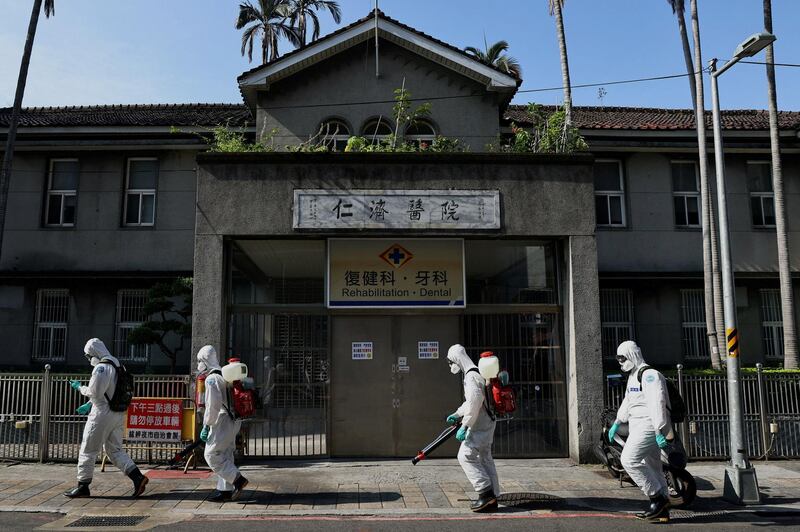 Soldiers disinfect Wanhua district, an area that has one of the most cases of coronavirus disease in the city, in Taipei, Taiwan. Reuters