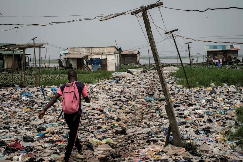 - AFP PICTURES OF THE YEAR 2019 - 

A man walks on plastic waste, used to reclaim a swamp so that the land can be developed for housing, in the Mosafejo area of Lagos on February 12, 2019. Nigeria, which elects a new president on February 16, is Africa's most populous nation and leading oil producer but is dogged by poverty and insecurity. - 
 / AFP / Yasuyoshi CHIBA
