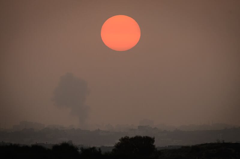 Smoke rises above buildings in Gaza city after an air strike, as seen from the border near Sderot in Israel. Getty Images