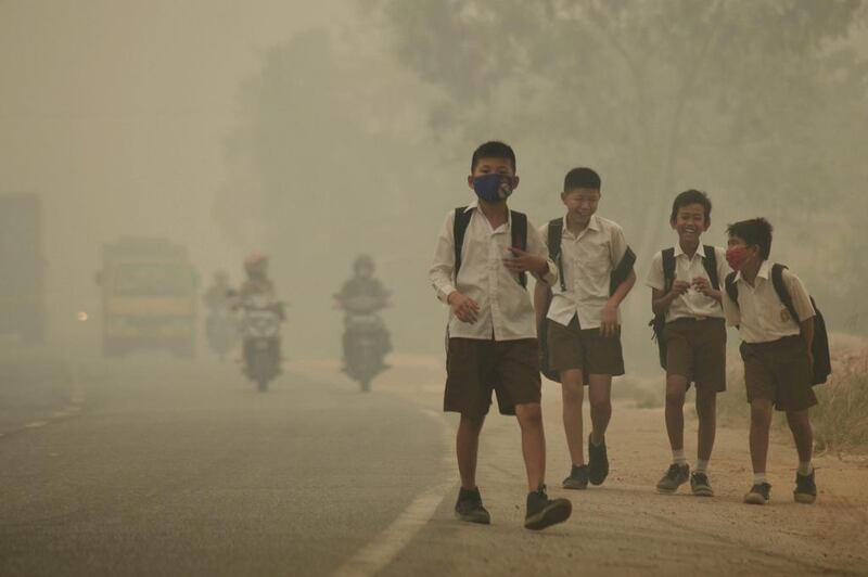 Students walk along a street as they are released from school to return home earlier due to the haze in Jambi, Indonesia's Jambi province on September 29, 2015. Wahdi Setiawan, Antara Foto/Reuters