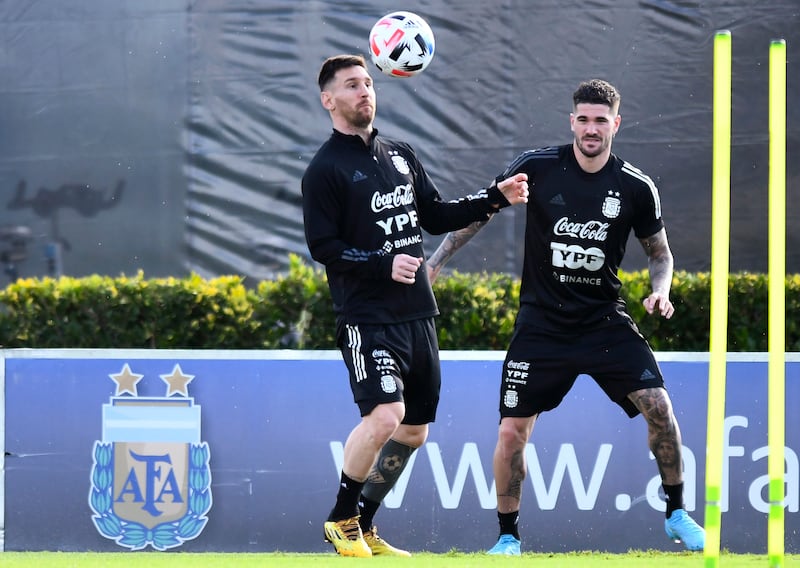 Lionel Messi heads the ball next to teammate Rodrigo De Paul. Getty
