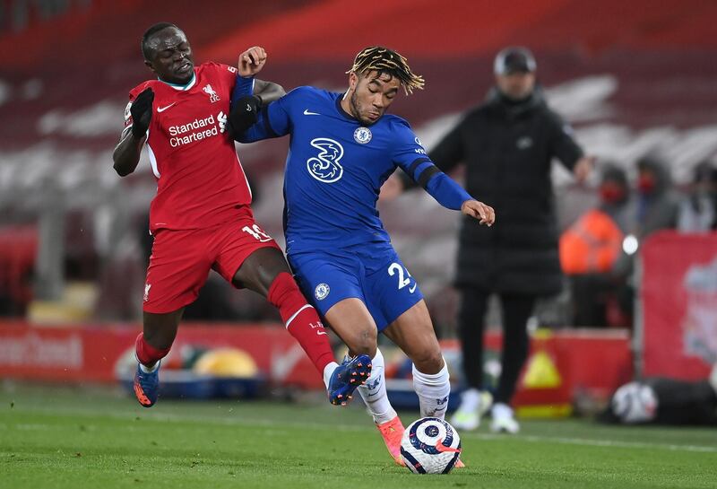 Liverpool's Sadio Mane, left, challenges for the ball with Chelsea's Reece James during the English Premier League soccer match between Liverpool and Chelsea at Anfield stadium in Liverpool, England, Thursday, March 4, 2021. (Laurence Griffiths, Pool via AP)