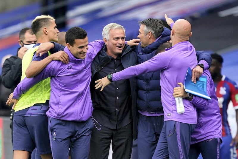 Tottenham Hotspur's Portuguese head coach Jose Mourinho (C) celebrates with his coaching staff after the English Premier League football match between Crystal Palace and Tottenham Hotspur at Selhurst Park in south London on July 26, 2020. (Photo by Will Oliver / POOL / AFP) / RESTRICTED TO EDITORIAL USE. No use with unauthorized audio, video, data, fixture lists, club/league logos or 'live' services. Online in-match use limited to 120 images. An additional 40 images may be used in extra time. No video emulation. Social media in-match use limited to 120 images. An additional 40 images may be used in extra time. No use in betting publications, games or single club/league/player publications. / 