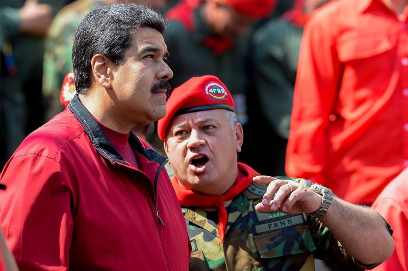 (FILES) In this file photo taken on February 04, 2016 Venezuelan President Nicolas Maduro (L) listens to deputy and former president of the National Assembly, Diosdado Cabello, during a ceremony to commemorate the 24th anniversary of former Venezuelan President Hugo Chavez's military coup against the government of Carlos Andres Perez (1989-1993), at Miraflores presidential palace, in Caracas. On June 19, 2018 Cabello was elected as the new president of the Venezuelan Constituent Assembly, replacing Delcy Rodriguez who was appointed by President Nicolas Maduro as his vice president. / AFP / Federico PARRA
