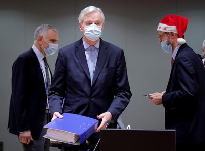 European Union's chief Brexit negotiator Michel Barnier holds the pages of Brexit trade deal as he attends a meeting of the Committee of the Permanent Representatives of the Governments of the Member States to the European Union (COREPER) in Brussels, Belgium December 25, 2020. Olivier Hoslet/Pool via REUTERS     TPX IMAGES OF THE DAY