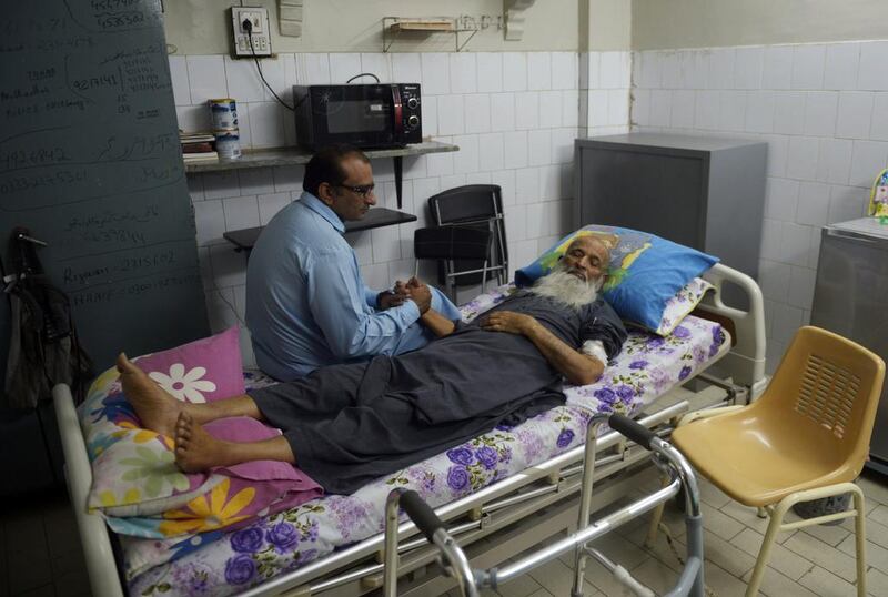 Abdul Sattar Edhi, head of Pakistan’s Edhi Foundation, with his son Faisal at the organisation’s centre in Karachi. After decades working around the clock on a punishing schedule, Mr Edhi’s health is now failing. Rizwan Tabassum / AFP