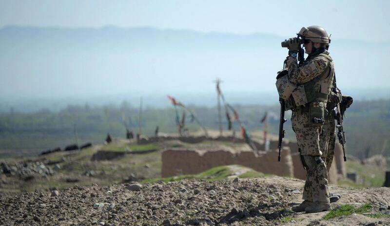 (FILES) In this file photo taken on April 02, 2012 a German soldier keeps watch during a patrol near Taloqan, the capital of Takhar province. Germany's defence ministry on April 21, 2021 said it planned to withdraw its troops from Afghanistan by early July, after the United States announced plans to pull out by September 11. / AFP / JOHANNES EISELE
