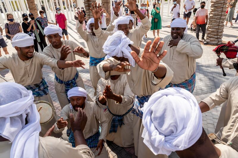 Emiratis and Omanis perform a traditional dance with traditional instruments native to the border areas that the two countries share.  Antonie Robertson / The National
