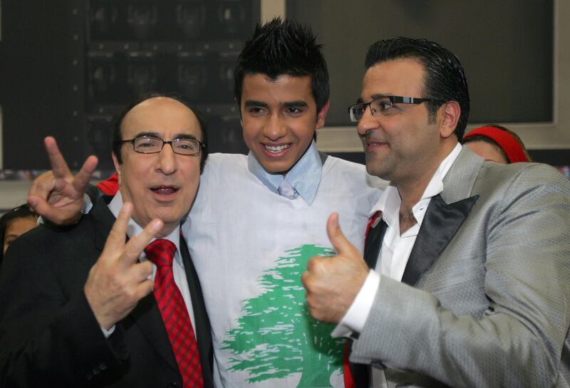 Lebanese national Elie Bitar (C) celebrates with composers Elias Rahbani (L) and Ziad Boutros after winning Season 5 of the "Super Star" title in Beirut on July 24 2008. 'Super Star' is the Arab version of the US Television talent show "American Idol". Bitar competed with 12 other participants from different Arab countries for the title. AFP PHOTO/ANWAR AMRO (Photo by ANWAR AMRO / AFP)