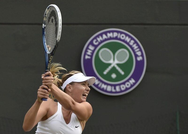 Maria Sharapova hits a return to Timea Bacsinszky during her second-round win at the 2014 Wimbledon Championships on Thursday. Toby Melville / Reuters / June 26, 2014