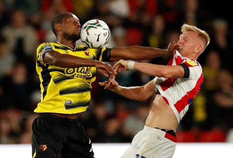 Watford's Christian Kabasele holds off Stoke City player Sam Surridge during a League Cup match at Vicarage Road on Tuesday, September 21. Reuters