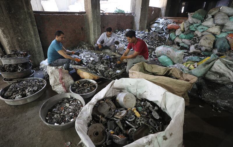 Workers sort aluminum items for recycling in Cairo, Egypt.
