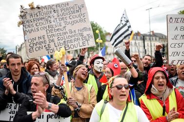 People take part in a demonstration called by the "Yellow vest" (Gilets jaunes) movement on May 11, 2019 in Nantes, western France. / AFP / Sebastien SALOM-GOMIS