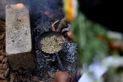 A Saudi farmer roasts Khawlani coffee beans at a coffee farm in Saudi Arabia's south-western region of Jizan, which is known for its red Khawlani beans. AFP