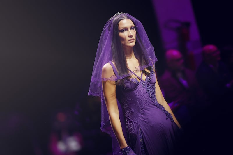 Bella Hadid sports a purple creation with veil for the Versace show during Milan Fashion Week on September 23, 2022 in Italy. Getty