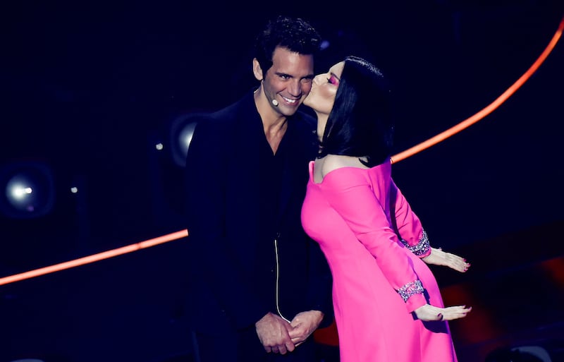 Laura Pausini kisses co-host Mika during the first semi-final. Reuters