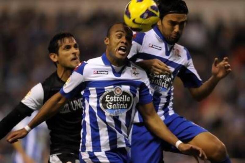 Deportivo Coruna, and their defender Evaldo, centre, with midfielder Abel Aguilar, right, are struggling in the Primera Liga. MIGUEL RIOPA / AFP