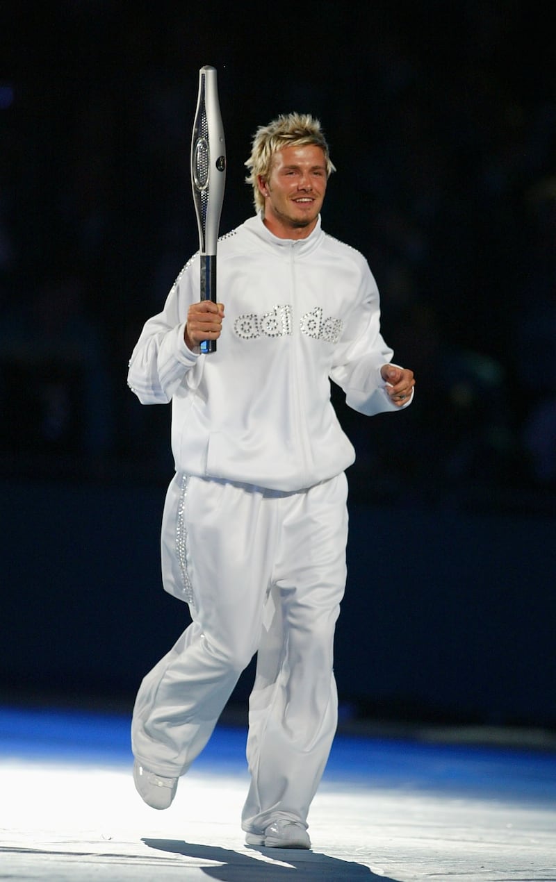 MANCHESTER - JULY 25:  David Beckham of Manchester and England runs whit the baton during the Opening Ceremony at the City of Manchester Stadium during the 2002 Commonwealth Games in Manchester, England on July 25, 2002. (Photo by Laurence Griffiths/Getty Images)