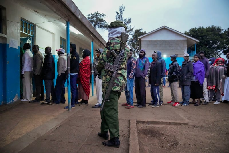 People line up to vote at the Kibera primary school in Nairobi. AP