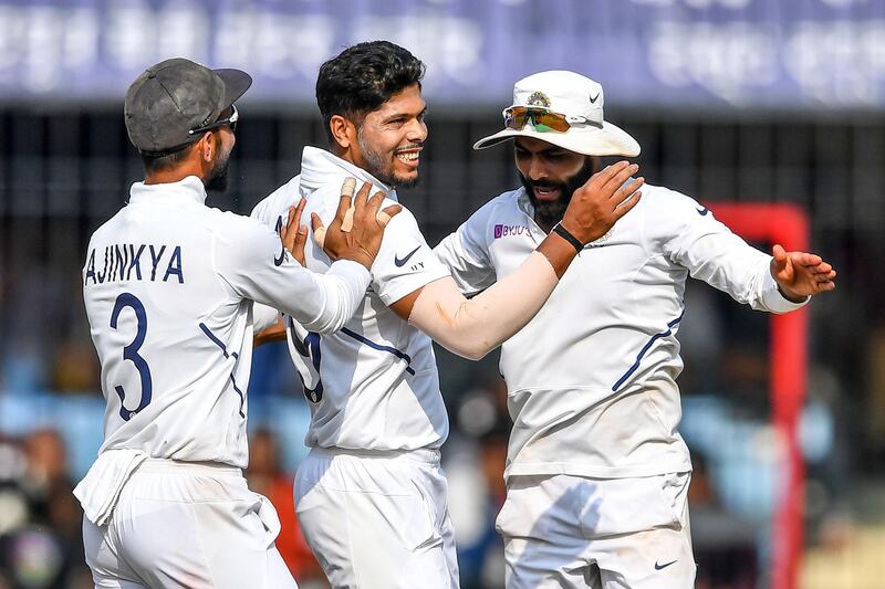 Umesh Yadav, centre, celebrates with India teammates Ajinkya Rahane and Ravindra Jadeja after the dismissal of Bangladesh's Mehidy Hasan. AFP