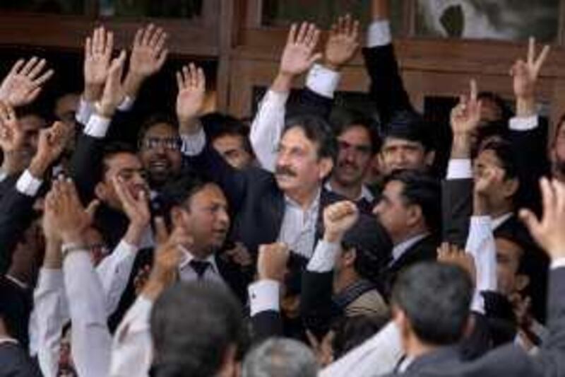 Pakistan's deposed Chief Justice Iftikhar Mohammed Chaudhry, center, is greeted by lawyers after the government announced to reinstate him at his residence in Islamabad, Pakistan on Monday, March 16, 2009. Pakistan's government relented in a major confrontation with the opposition, agreeing to reinstate Chaudhry whose fate had sparked street fights and raised fears of political instability in a country battling rising Islamist violence. (AP Photo/Anjum Naveed) *** Local Caption ***  XAN109_Pakistan.jpg