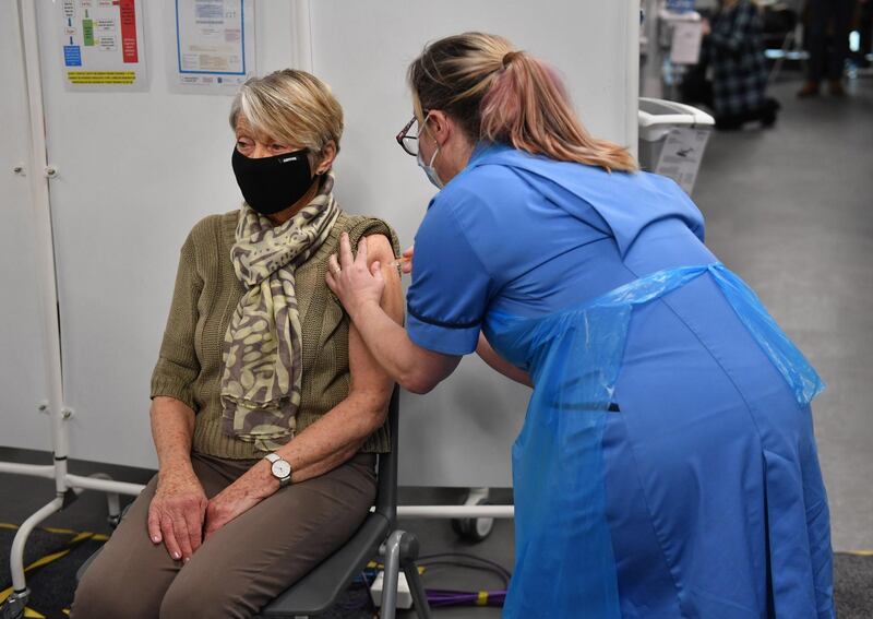 epa08931984 Rita Passey receives an injection of a Covid-19 vaccine at the NHS vaccine centre that has been set up at the Millennium Point centre in Birmingham, Britain 11 January 2021. The UK government has announced that mass vaccination centres will start operating from 11 January in London, Newcastle, Manchester, Birmingham, Bristol, Surrey and Stevenage.  EPA/JACOB KING / POOL