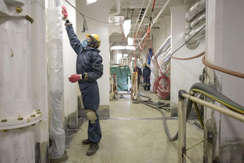 A worker prepares a hallway for painting below the decks of an under-construction Maersk triple-E class container ship. Ed Jones / AFP