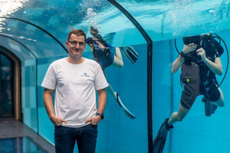 Deepspot director Michal Braszczynski poses at the deepest pool in the world with 45.5-metre (150-foot) located in Mszczonow about 50 km from Warsaw, November 21, 2020.  The complex, named Deepspot, even includes a small wreck for scuba and free divers to explore. It has 8,000 cubic metres of water -- more than 20 times the amount in an ordinary 25-metre pool.
 / AFP / Wojtek RADWANSKI / TO GO WITH AFP STORY 
