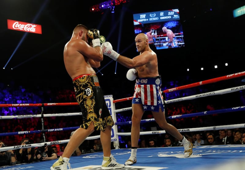 Tyson Fury and Tom Schwarz in action. REUTERS