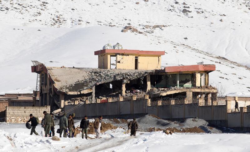 epaselect epa07306335 Afghan intelligence officers leave the collapsed building of Afghanistan's intelligence office following an attack in Wardak, Afghanistan, 21 January 2019. A Taliban Humvee tank full of explosive materials targeted the building with following attack of several other insurgents early in the morning.  According to the Afghan officials at least 18 officers were killed and 50 others wounded.  EPA/JAWAD JALALI