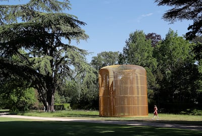 Hannah Vitos of the Blenheim Art Foundation, poses for a photograph next to artist Ai Weiwei's Gilded Cage (2017) sculpture in the grounds of Blenheim Palace in Woodstock, Britain, June 2, 2021.  REUTERS/Peter Nicholls