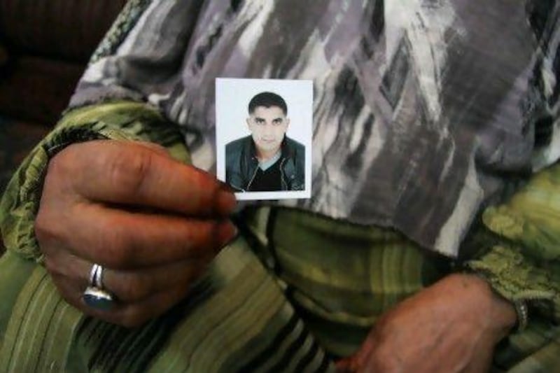 Mabrouka Hillal holds a picture of her son, Walid, thought to have been killed while fighting in Syria.