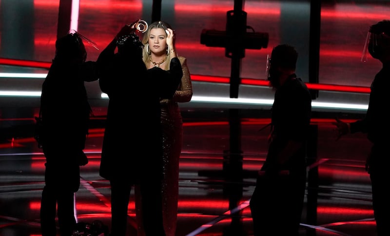 Host Kelly Clarkson has her make-up retouched before the start of the Billboard Music Awards. AP