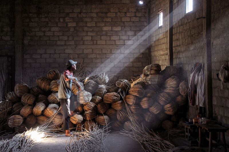 A craftsman works on unusual rattan coffins at Trangsan hamlet in Sukoharjo, Indonesia. AFP