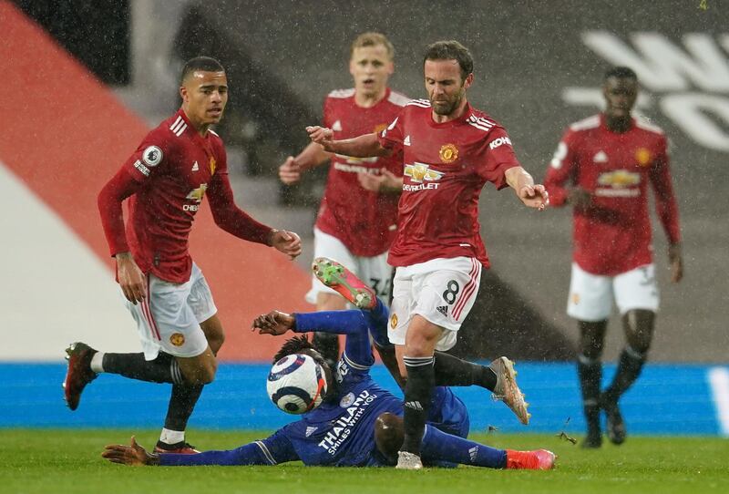 Leicester midfielder Wilfred Ndidi slides in to challenge United's Juan Mata at Old Trafford. Reuters