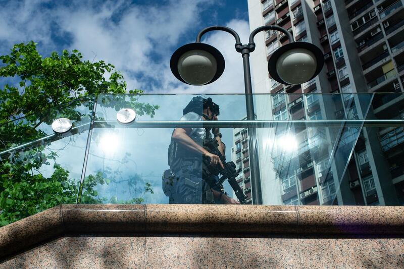 An armed Counter Terrorism Response Unit officer patrols outside a shopping mall at the scene of a shooting in Hong Kong's Quarry Bay Park near Taikoo Shing on June 26, 2018. Philip Fong / AFP