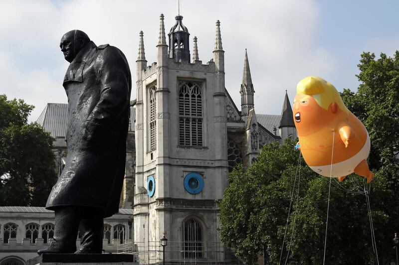A six-meter high cartoon baby blimp of  Trump hovers next to the statue of former British Prime Minister Winston Churchill. AP Photo