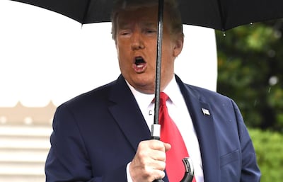 U.S. President Donald Trump holds an umbrella while speaking to members of the media on the South Portico of the White House before boarding Marine One in Washington, D.C., U.S., on Saturday, June 20, 2020. Attorney General William Barr said Trump has fired Geoffrey S. Berman, the chief federal prosecutor in New York, after he refused to step down. Photographer: Mike Theiler/UPI/Bloomberg