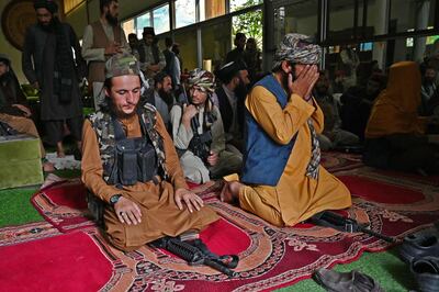Taliban fighters praying inside the seized Kabul home of Afghan warlord Abdul Rashid Dostum in September 2021. AFP