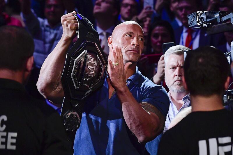 Dwane "The Rock" Johnson holds the belt for the welterweight bout between Jorge Masvidal and Nate Diaz during UFC 244 at Madison Square Garden. AFP