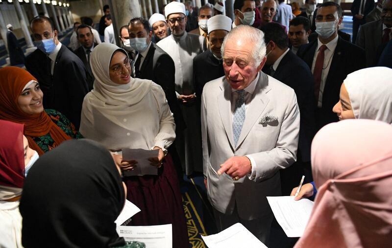 Prince Charles surrounded by students during his visit to Al Azhar Mosque.  AFP