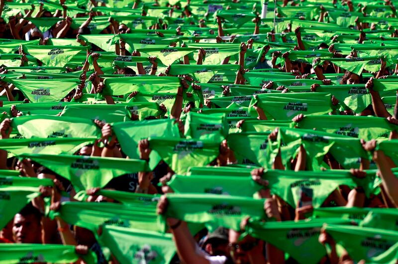 Spaniards hold bandanas reading "Abolition Mission" during a demonstration against bullfighting and animal abuse at the Puerta del Sol square in Madrid. AFP