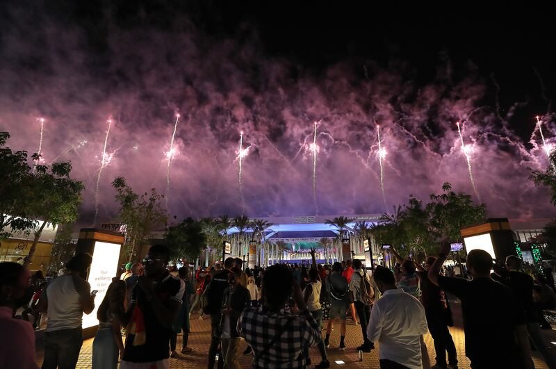 Visitors watch the fireworks display over Al Wasl Avenue at Expo 2020 Dubai.