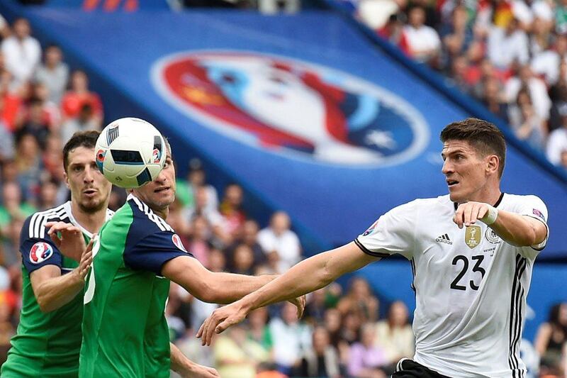 Germany's forward Mario Gomez (R) and Northern Ireland's defender Craig Cathcart and Northern Ireland's defender Aaron Hughes vie for the ball during the Euro 2016 group C football match between Northern Ireland and Germany at the Parc des Princes stadium in Paris on June 21, 2016. / AFP / LIONEL BONAVENTURE